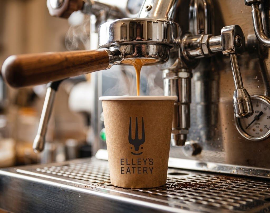 Espresso pouring into a kraft cup